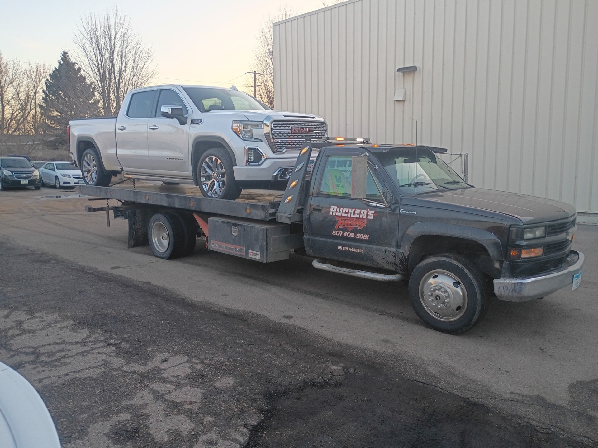 Ruckers Towing flatbed loaded with a GMC Denali pickup